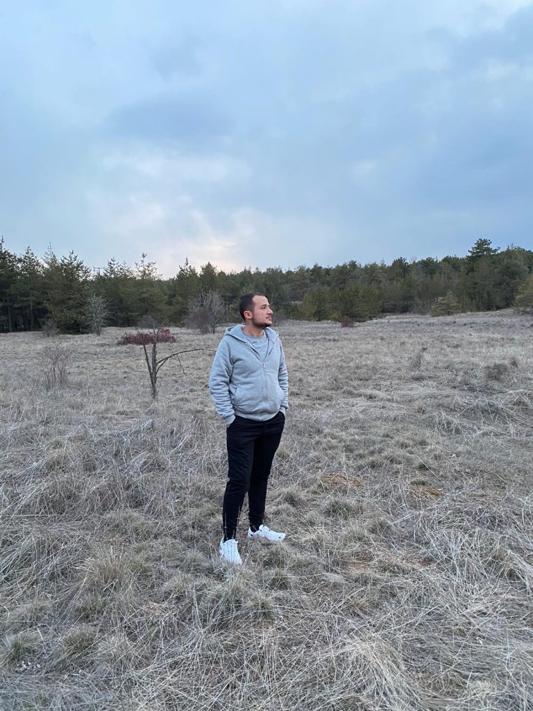 Jane leaning against a bus